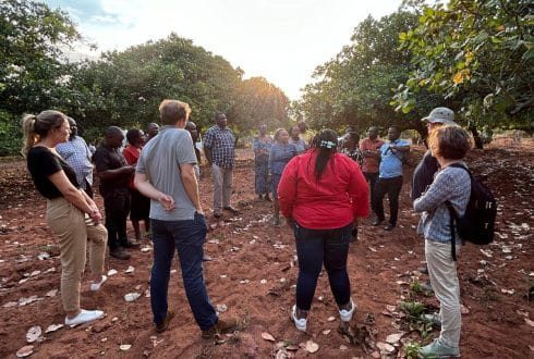 Farmers and TARI team discussing new trees and agricultural practices in Tanzania.